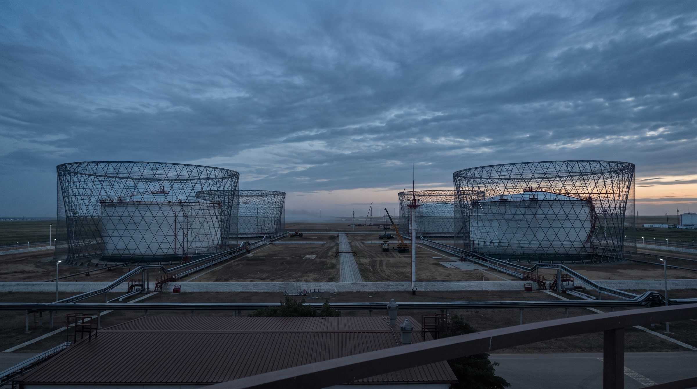 A multi-tank storage site with a steel lattice structure erected over each tank